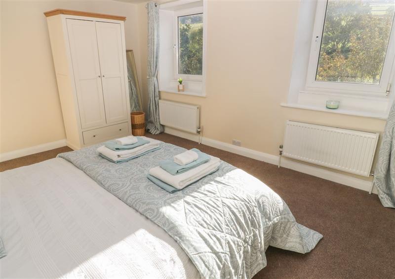 A bedroom in Riverview Cottage at Riverview Cottage, Holmbridge