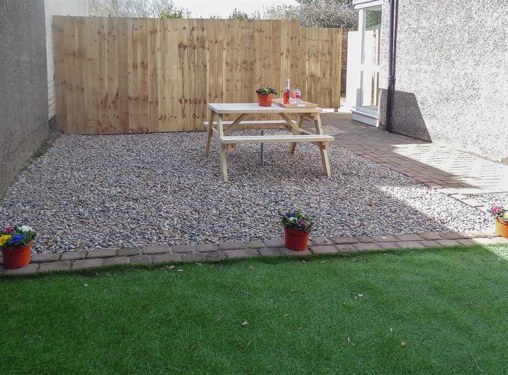 Courtyard-style garden space with picnic table at Robins Nest in Broomhill, near Amble, Northumberland