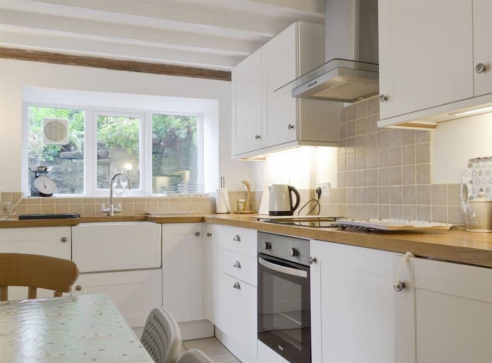 Well-equipped kitchen with dining area at Rock Cottage in Birchover, near Matlock, Derbyshire