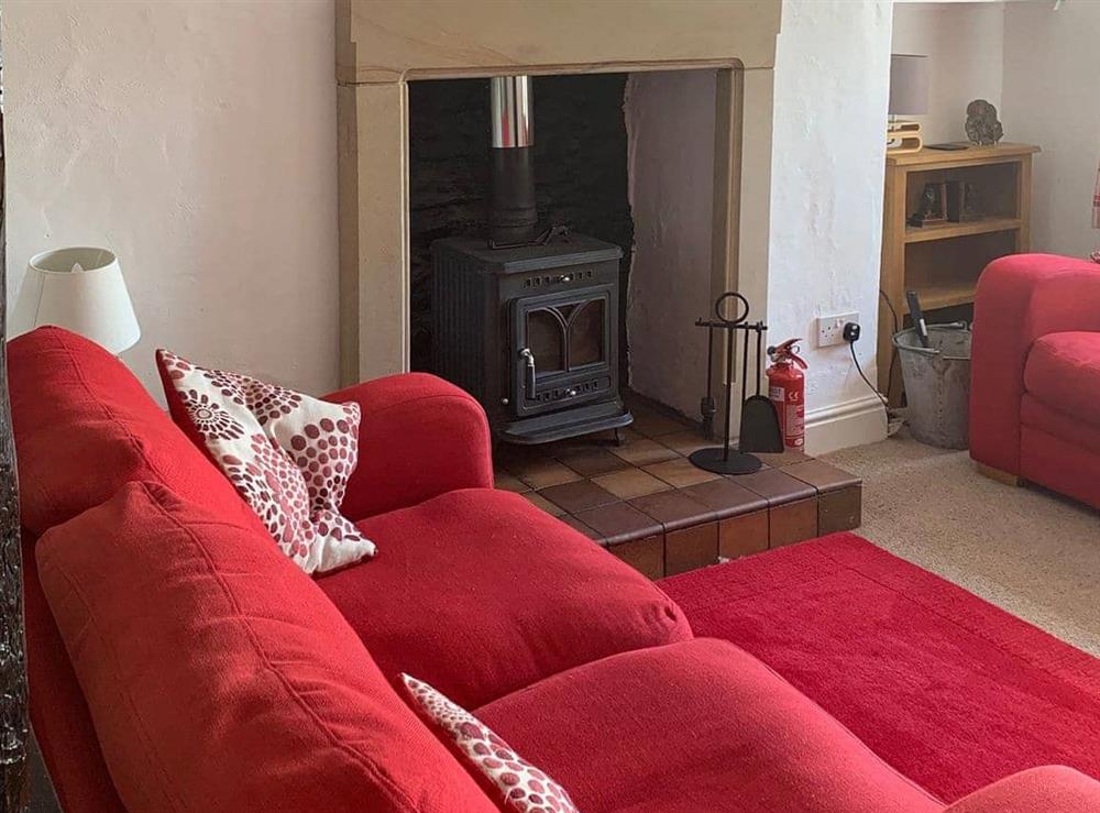 Cosy, beamed living room with wood burning stove at Rock Cottage in Kendal, Cumbria