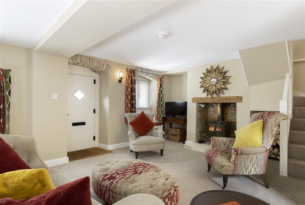 A warm welcome awaits in this light and spacious, tastefully decorated sitting room at Rock Cottage, Minchinhampton