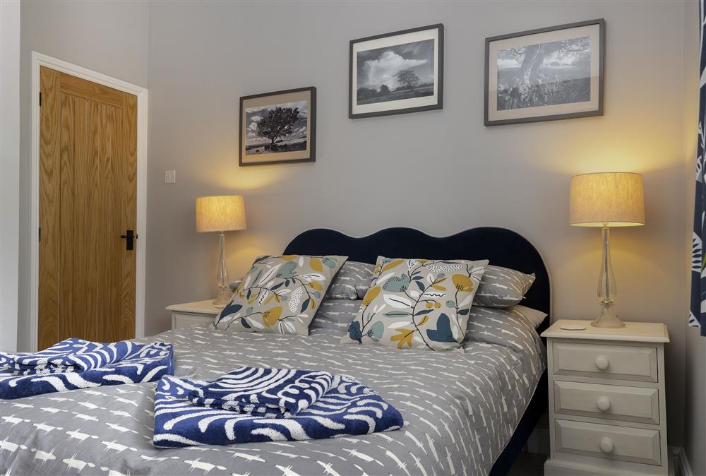 First floor: Bedroom one elegantly furnished with a 4ft6 double bed at Rock Cottage, Minchinhampton