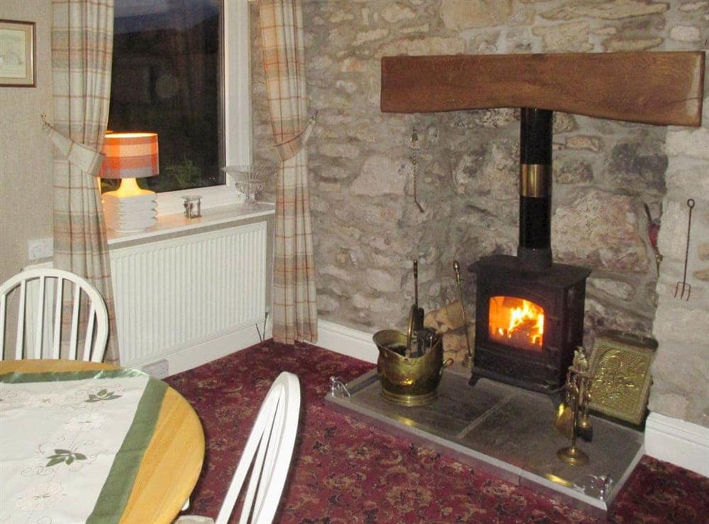 Dining room with cosy wood burner at Rock Villas in Silverdale, near Carnforth, Lancashire