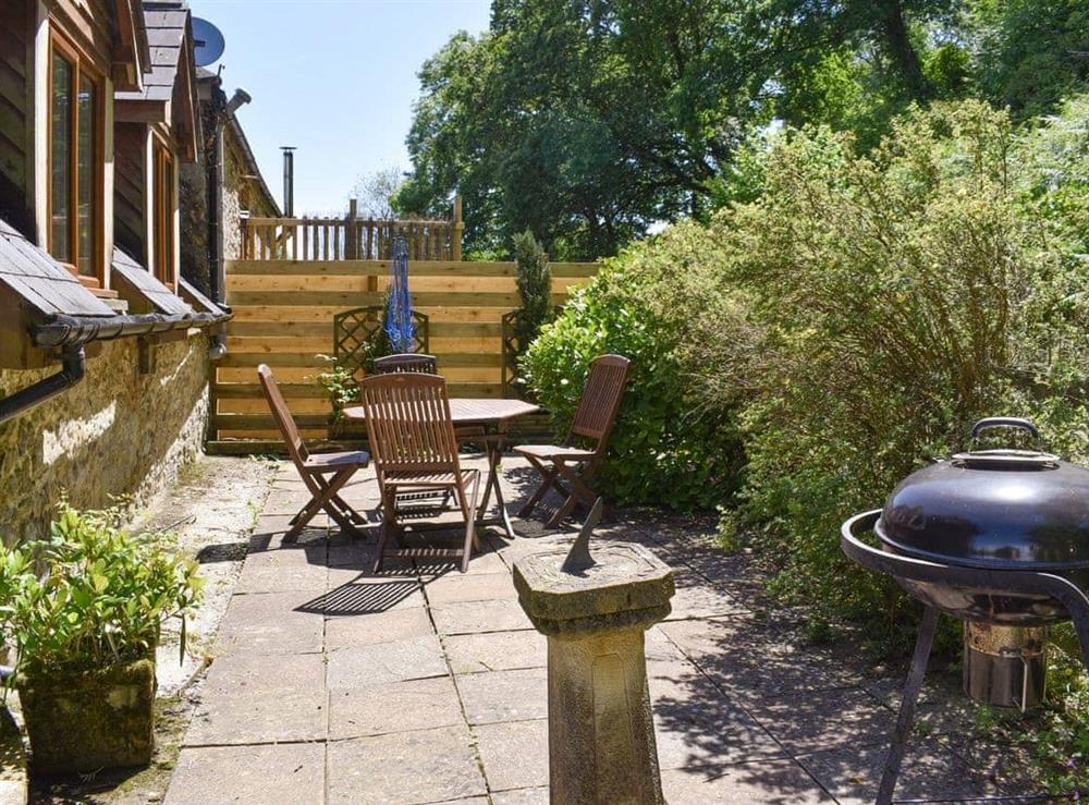 Patio area with outdoor furniture and BBQ at Clock Cottage, 