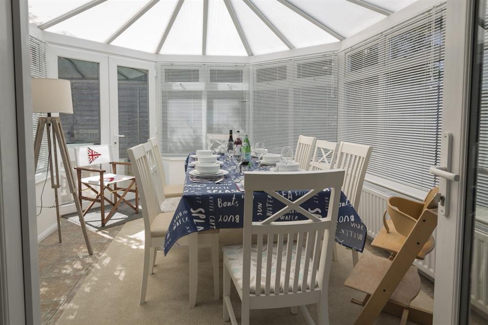 The sitting room opens into the conservatory/dining room at Rockpoint in , Salcombe