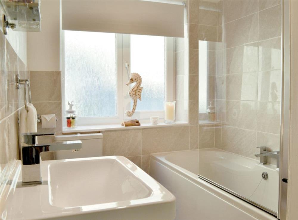 Modern bathroom with shower over the bath at Rockpool Cottage in Saltburn-by-the-Sea, North Yorkshire
