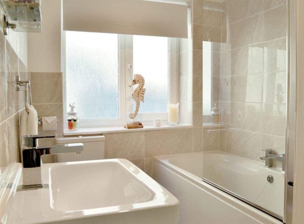 Modern bathroom with shower over the bath at Rockpool Cottage in , Staithes near Whitby