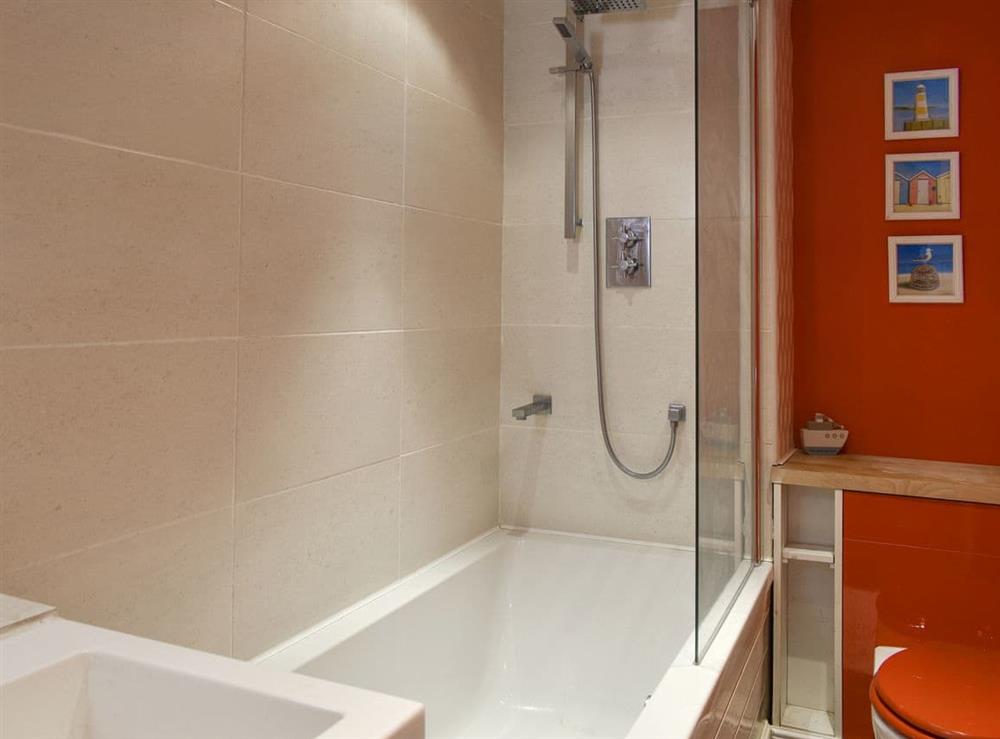 Family bathroom with shower over bath at Rodwell Trail Cottage in Weymouth, Dorset