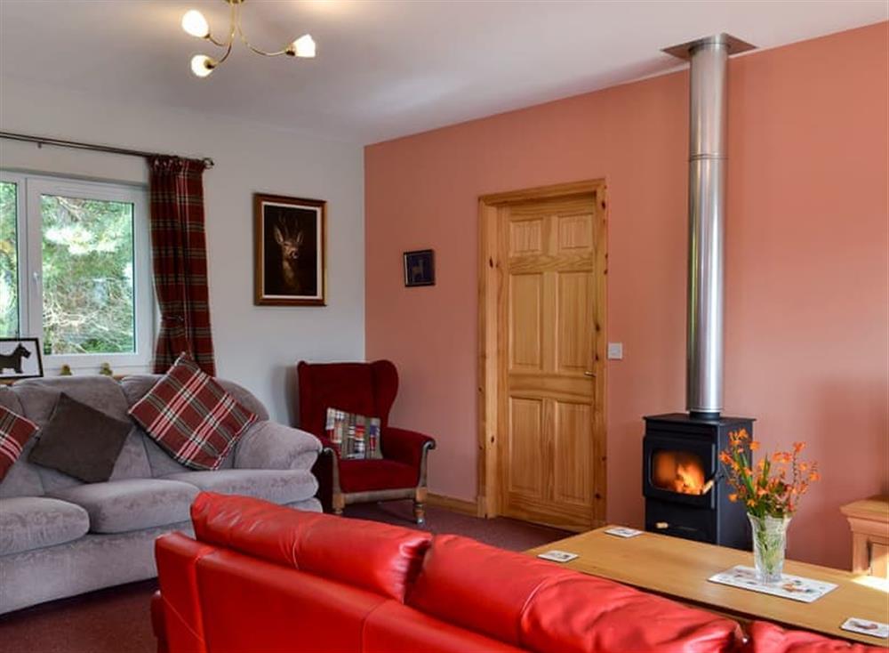 Comfortable living room with wood burner (photo 2) at Roe Deer Cottage in Broallan, near Beauly, Inverness-Shire