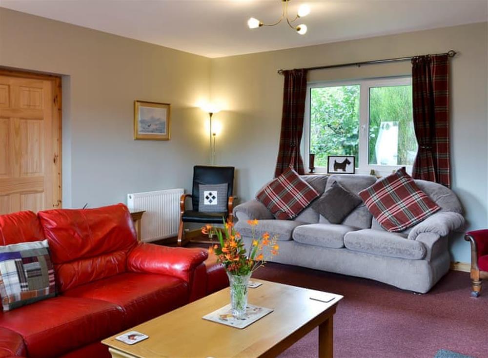 Comfortable living room with wood burner (photo 3) at Roe Deer Cottage in Broallan, near Beauly, Inverness-Shire