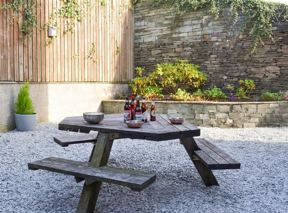 Courtyard garden with outdoor furniture at Rolton House in Ambleside, Cumbria