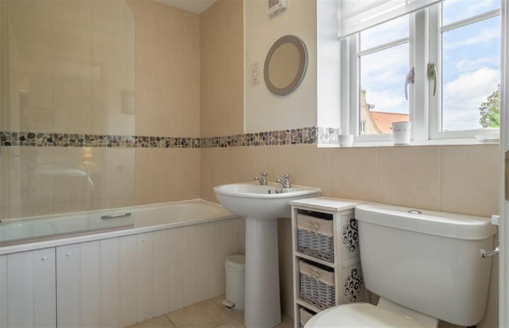 First floor: En-suite bathroom has bath and shower over at Roof Top View, Wells-next-the-Sea