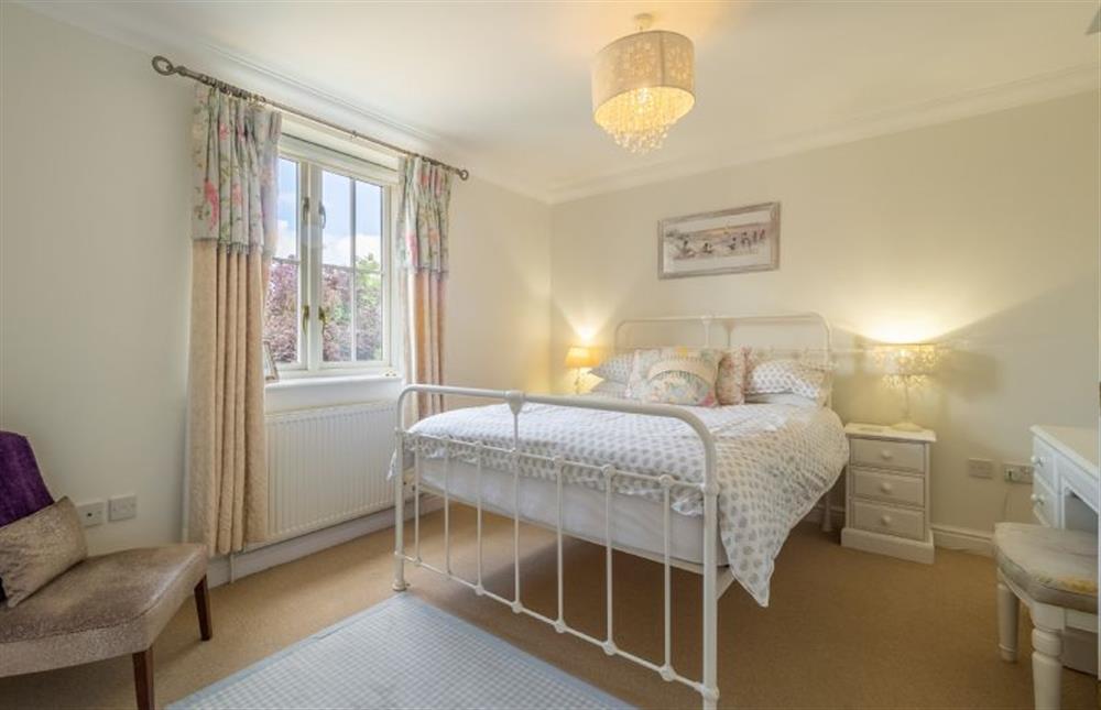 First floor: Master bedroom has wrought iron double bed at Roof Top View, Wells-next-the-Sea
