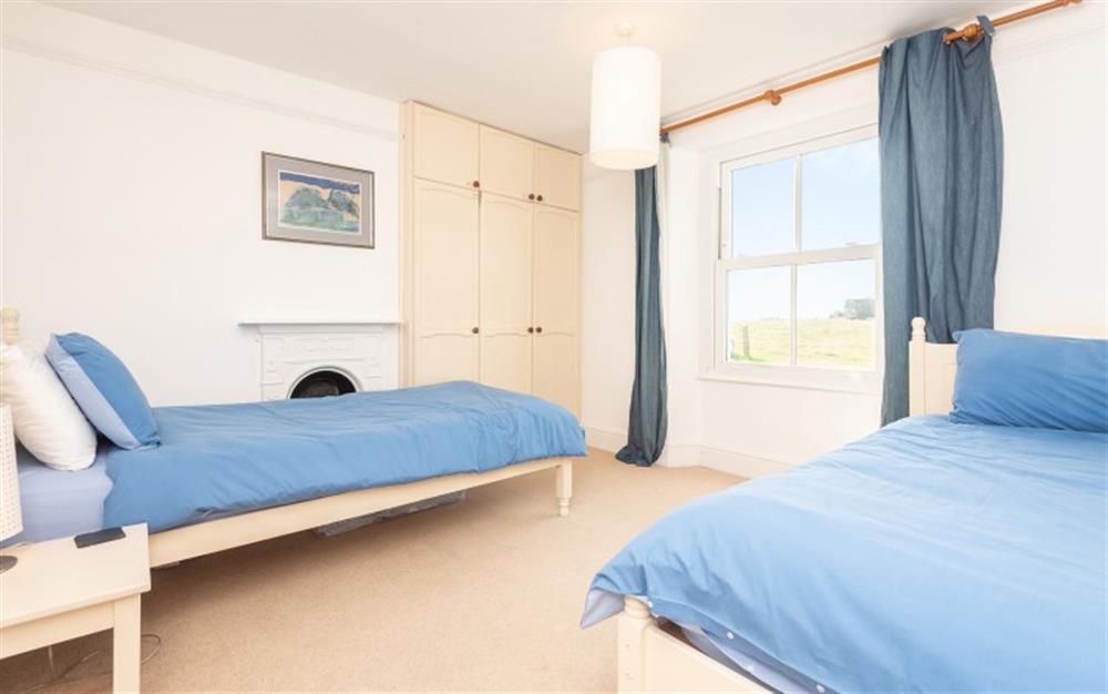 The twin bedroom looks over the lane and into neighbouring fields at Rosario in East Prawle