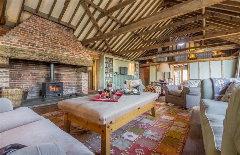 Living space with fireplace and wood burning stove at Rose and Court Barn, Stoke By Nayland