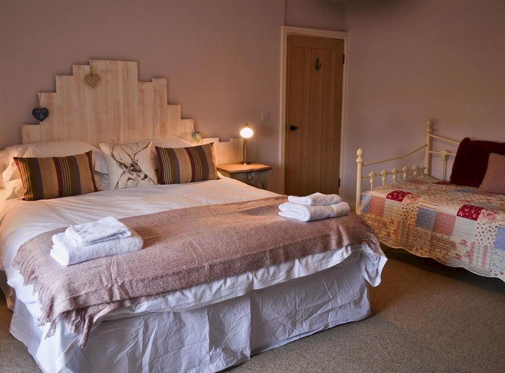 Super kingsize bed with single day bed at Rose Cottage in Beadnell, Northumberland