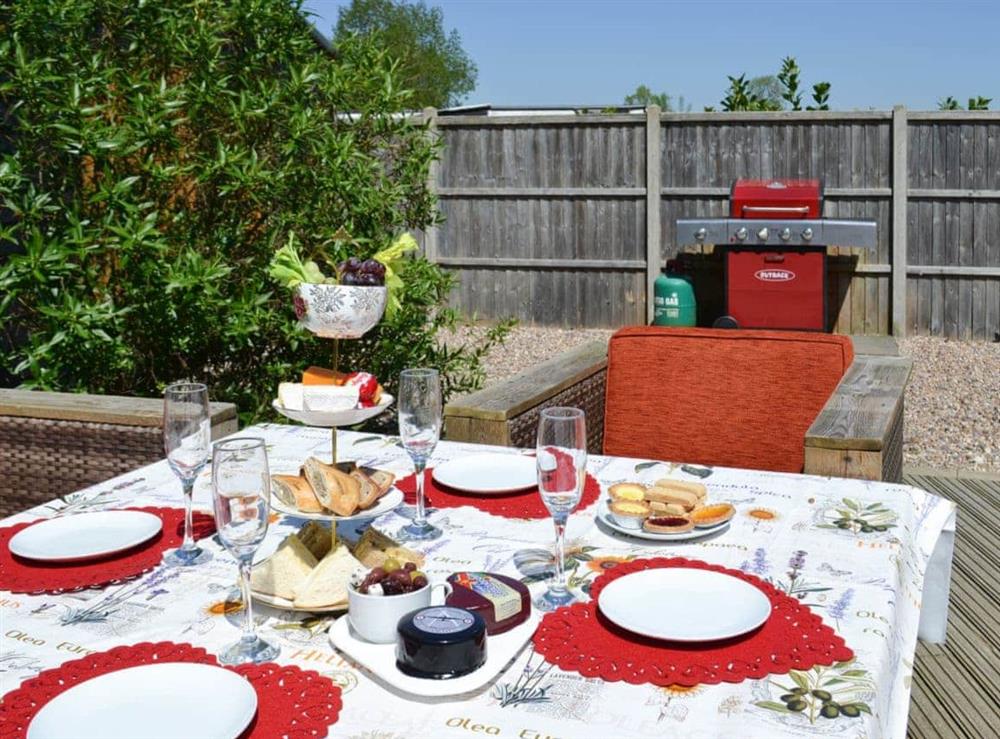 Lovely patio area with barbecue and table abd chairs at Rose Cottage in Bratoft, near Burgh-le-Marsh, Lincolnshire