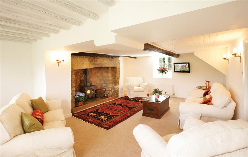 Sitting room with inglenook fireplace and wood burning stove at Rose Cottage (Dorset), Powerstock