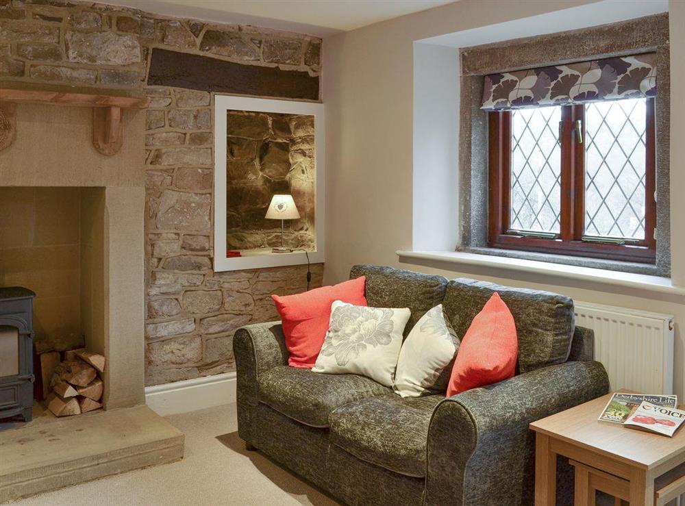 Cosy living room with wood burner at Rose Cottage in Grindleford, near Bakewell, Derbyshire