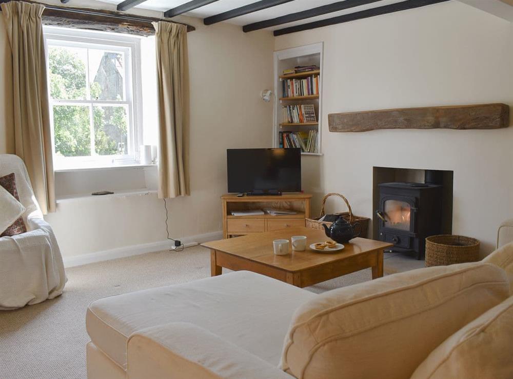 Characterful living room with multi fuel burner at Rose Cottage in Houlsyke, near Whitby, North Yorkshire