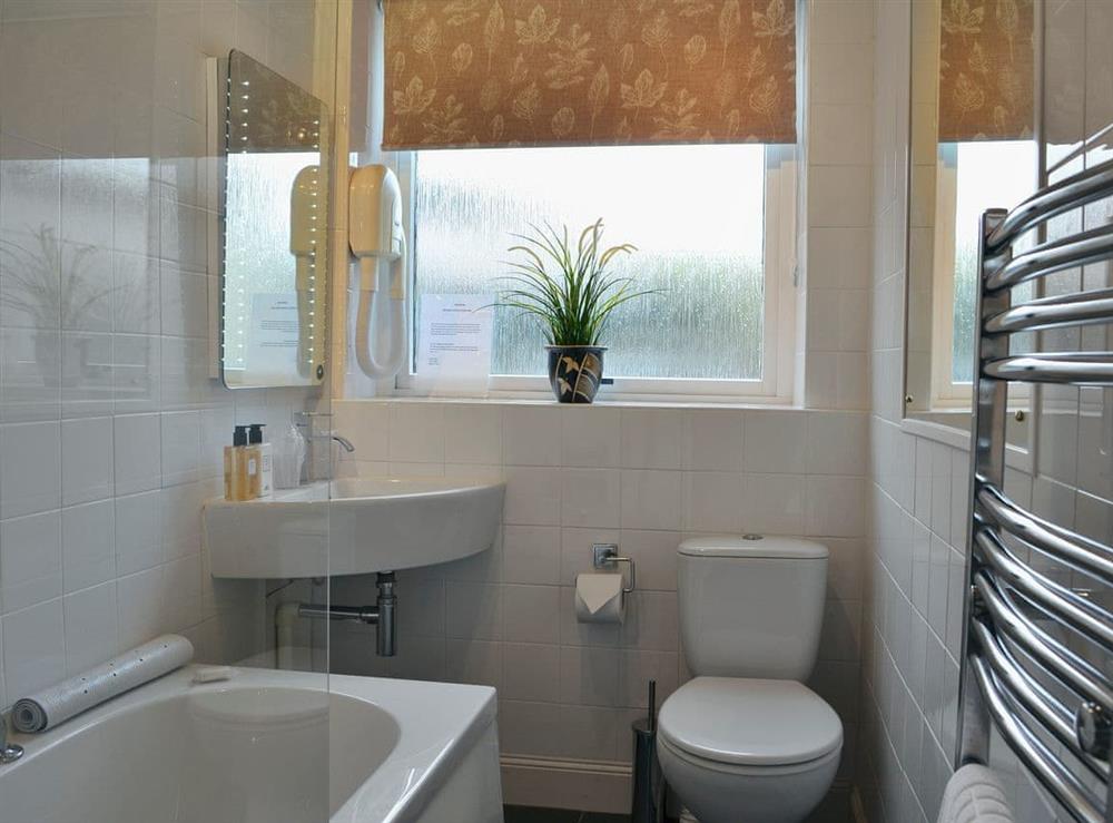 Well presented bathroom with shower over bath at Rose Cottage in Norham, near Berwick-upon-Tweed, Northumberland