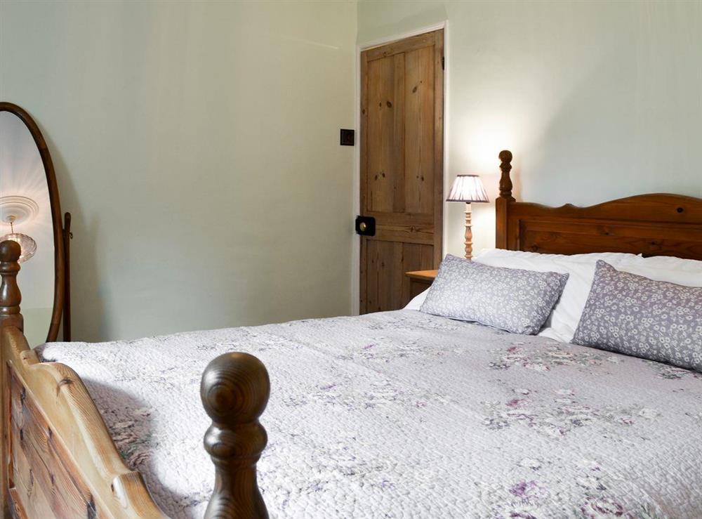 Relaxing bedroom with king-size bed at Rose Cottage in Saffron Walden, Essex