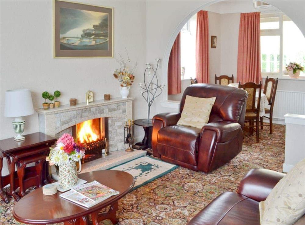 Cosy living room with open fire at Rose Cottage in Scarisbrick, near Southport, Lancashire