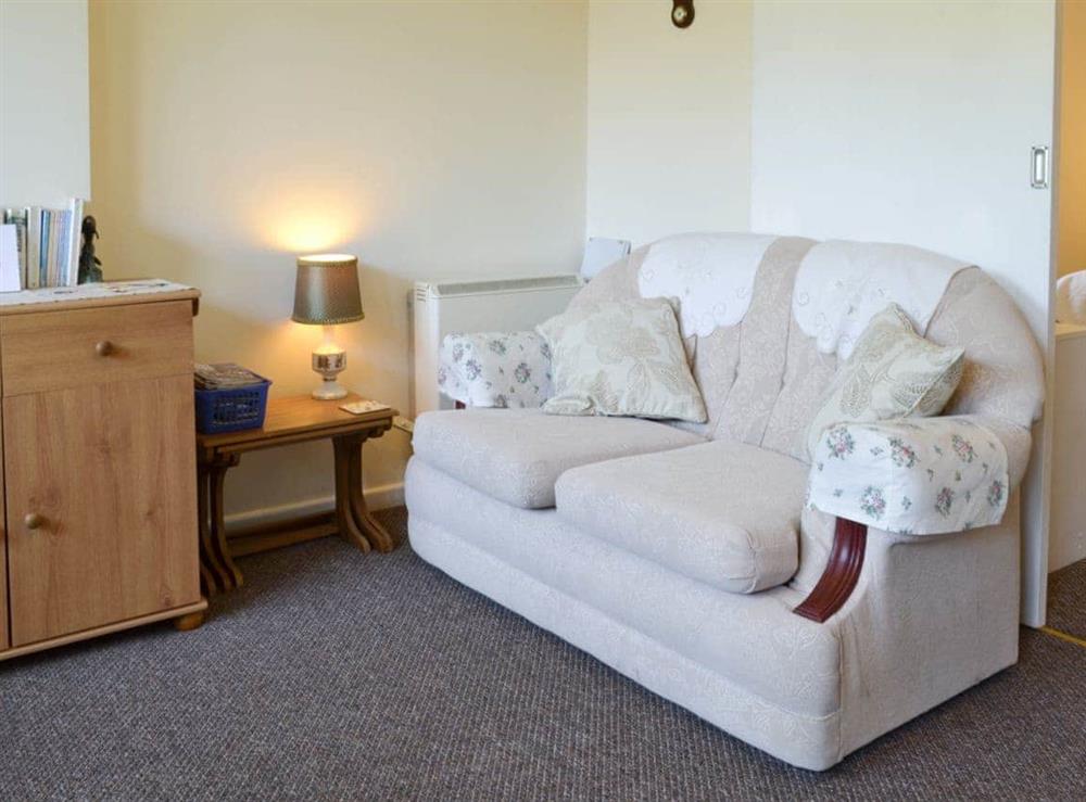 Comfortable seating within the open-plan living space at Rose Cottage in Scarning, near Dereham, Norfolk