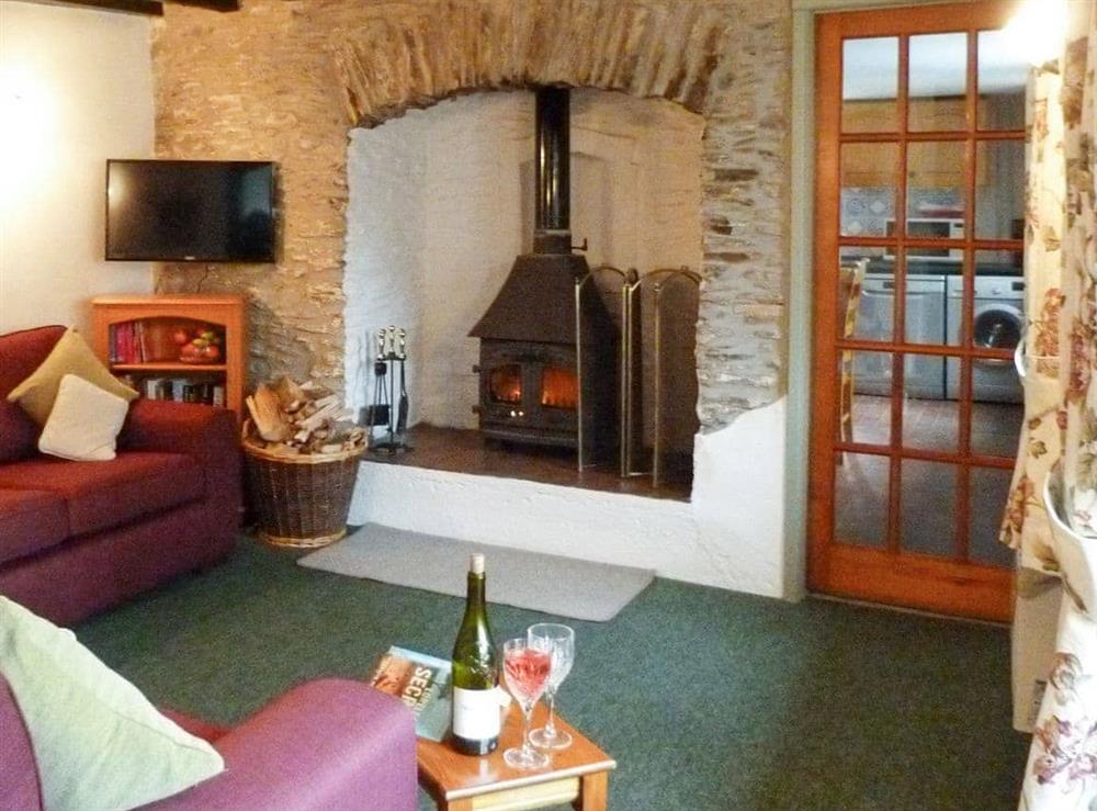 Welcoming living room with wood burner at Rose Cottage in Wheddon Cross, Exmoor, Somerset