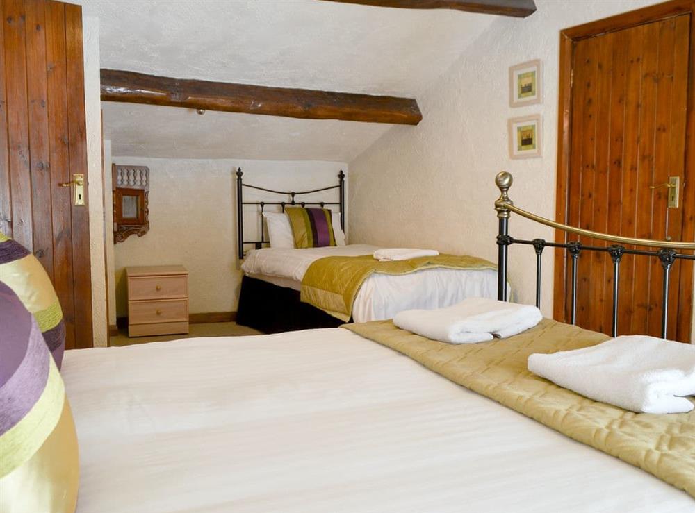 Large en-suite bedroom with double and single bed at Rose Patch Cottage in Keswick, Cumbria