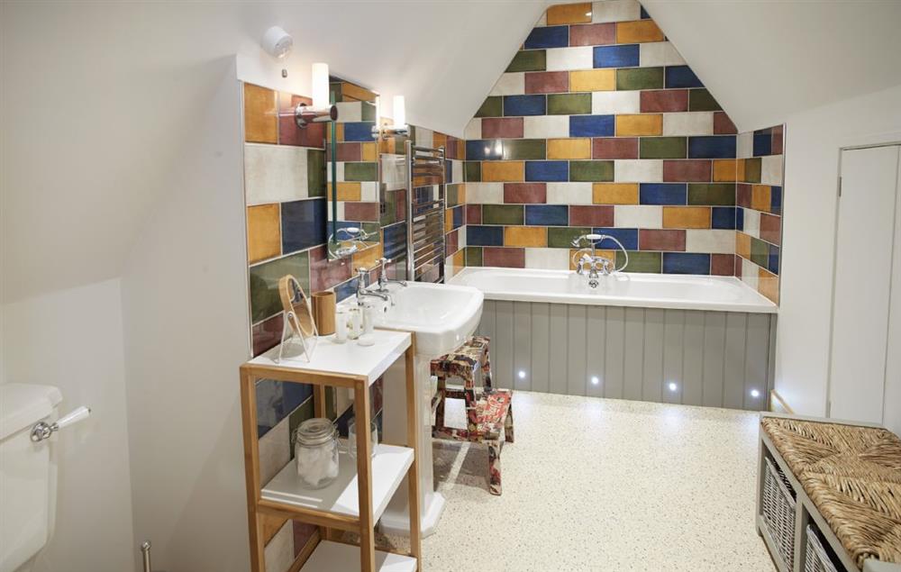 En-suite bathroom with bath and hand-held shower attachment at Rosebank Barn, Ablington