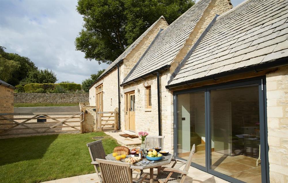 The bi-fold doors from the kitchen open out onto a charming patio and enclosed lawned garden with views on to open countryside