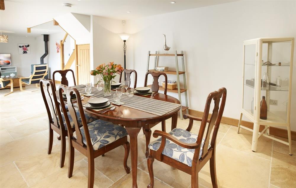 The open plan dining area has a large dining table seat six at Rosebank Barn, Ablington