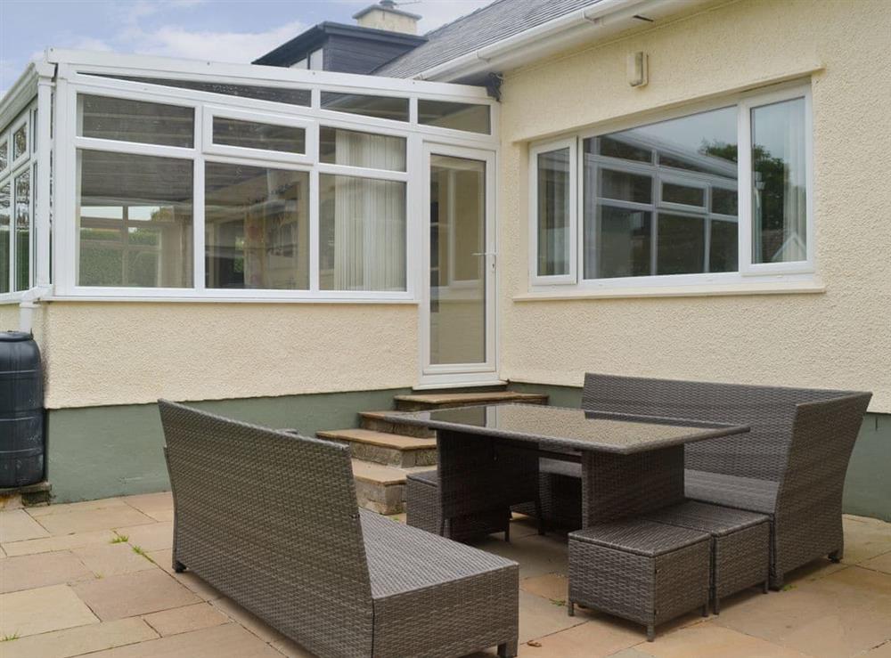 Paved patio area with outdoor furniture at Rosedale in Benllech, near Llangefni, Anglesey, Gwynedd