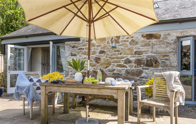 Enjoy a glass of wine on the patio at Rosehendra, Cornwall