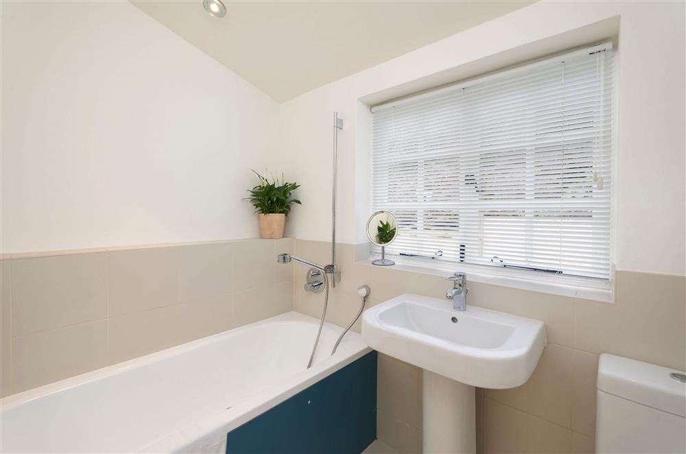 First floor: Family bathroom with bath and over-head shower at Rosemary Cottage, Dittisham