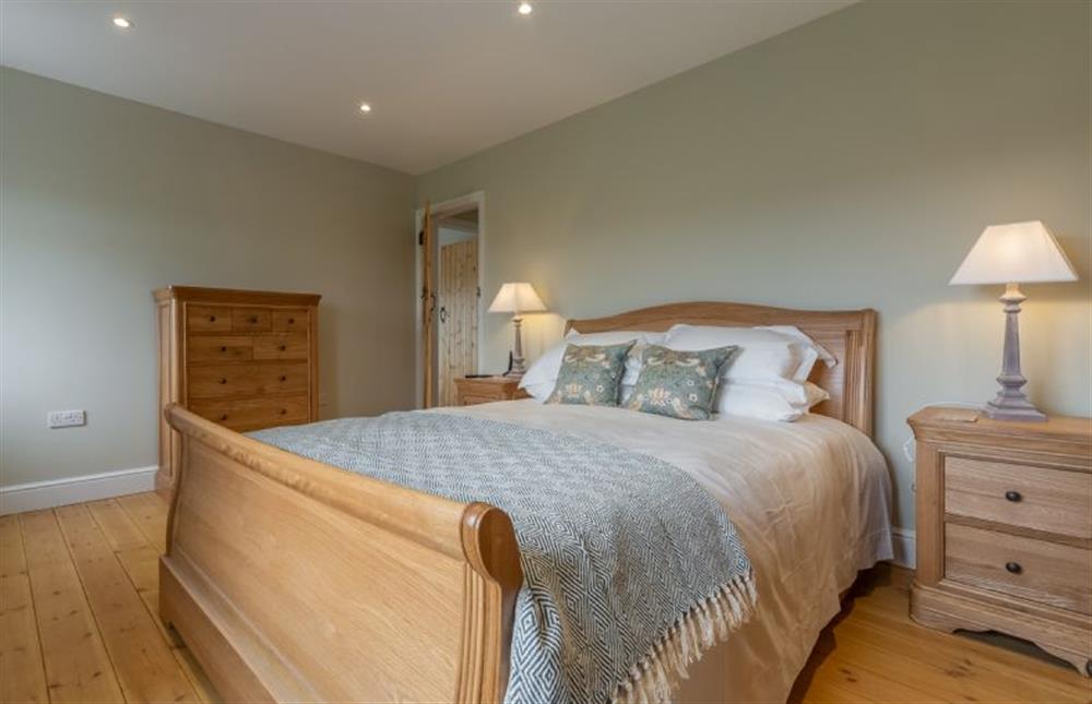 First floor: Bedroom two has a double oak sleigh bed at Rosemary Cottage, Thornham near Hunstanton