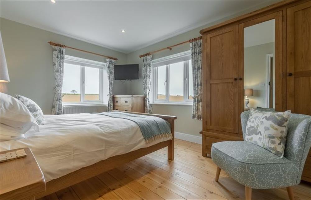 First floor: Lovely duel aspect master bedroom at Rosemary Cottage, Thornham near Hunstanton