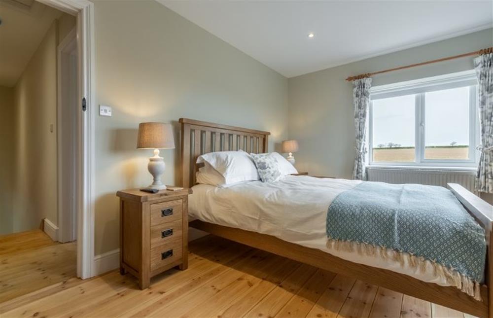First floor: Master bedroom has a double bed at Rosemary Cottage, Thornham near Hunstanton