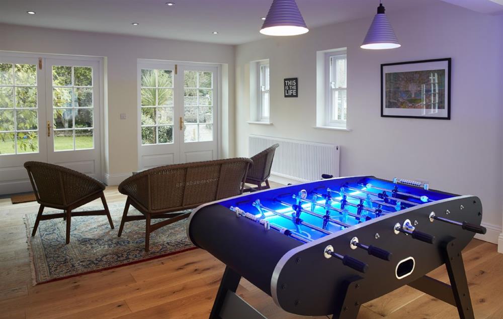 Large games room with table football and French windows leading to west facing patio at Rosevean House, St. Agnes