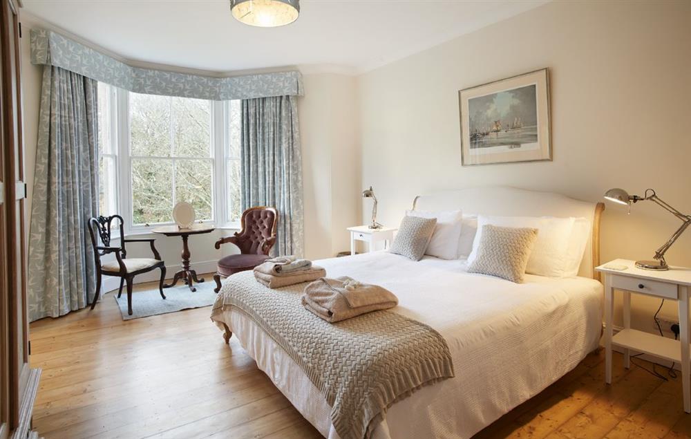 Master bedroom with 6’ super king size bed, en-suite bathroom and bay window overlooking the garden