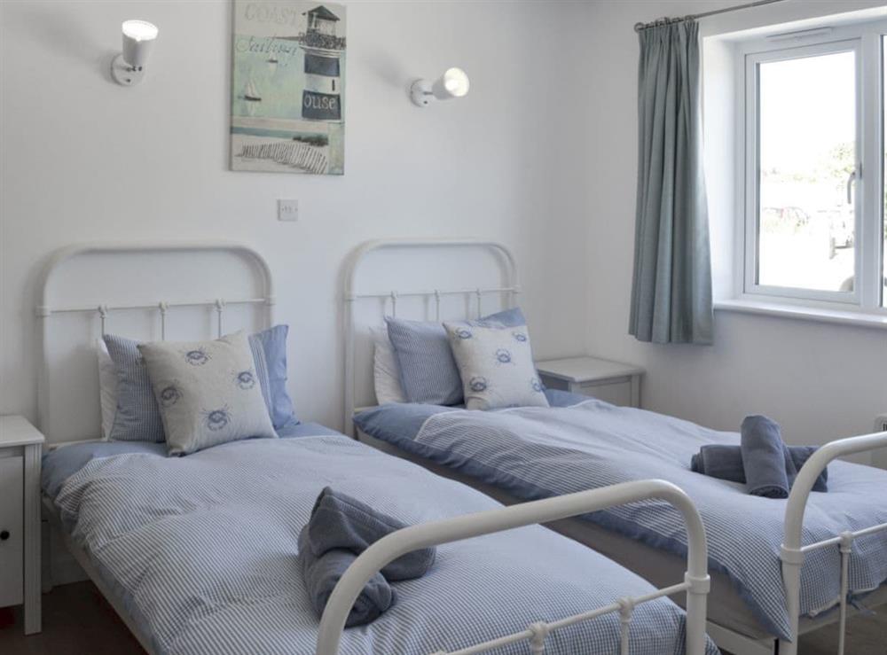 Tranquil bedroom with twin beds at Roskear in Crackington Haven, near Bude, Cornwall