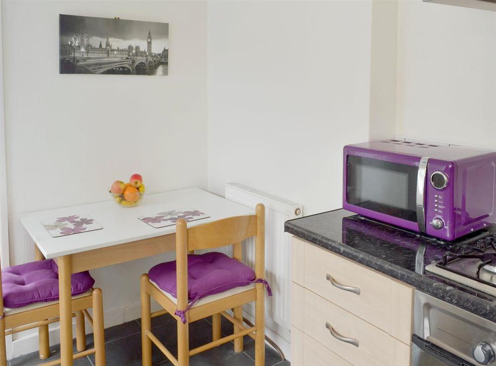 Convenient informal dining area in kitchen at Rossall Beach Cottage in Rossall, near Thornton-Cleveleys, Lancashire, England