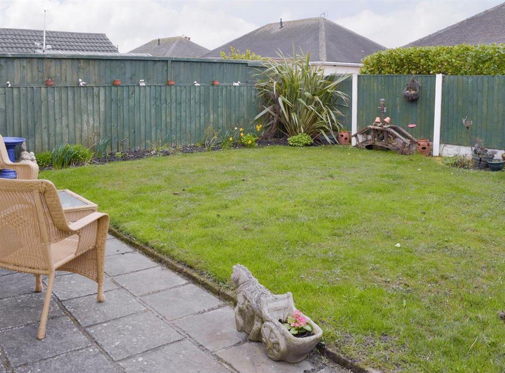 Enclosed rear lawned garden at Rossall Beach Cottage in Rossall, near Thornton-Cleveleys, Lancashire, England