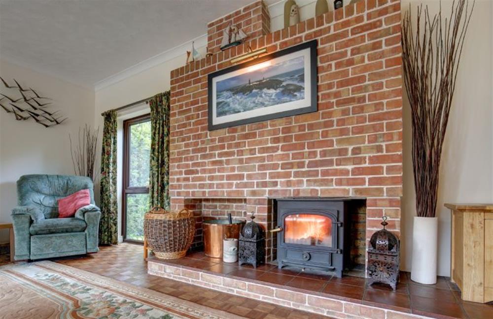 The wood burning stove makes the sitting room cosy in winter at Rossmore, Holme-next-the-Sea near Hunstanton