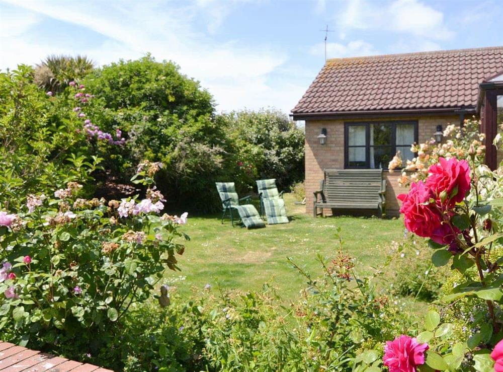 Well-maintained lawned garden with sitting out areas at Rothiemay in Walcott, Norfolk