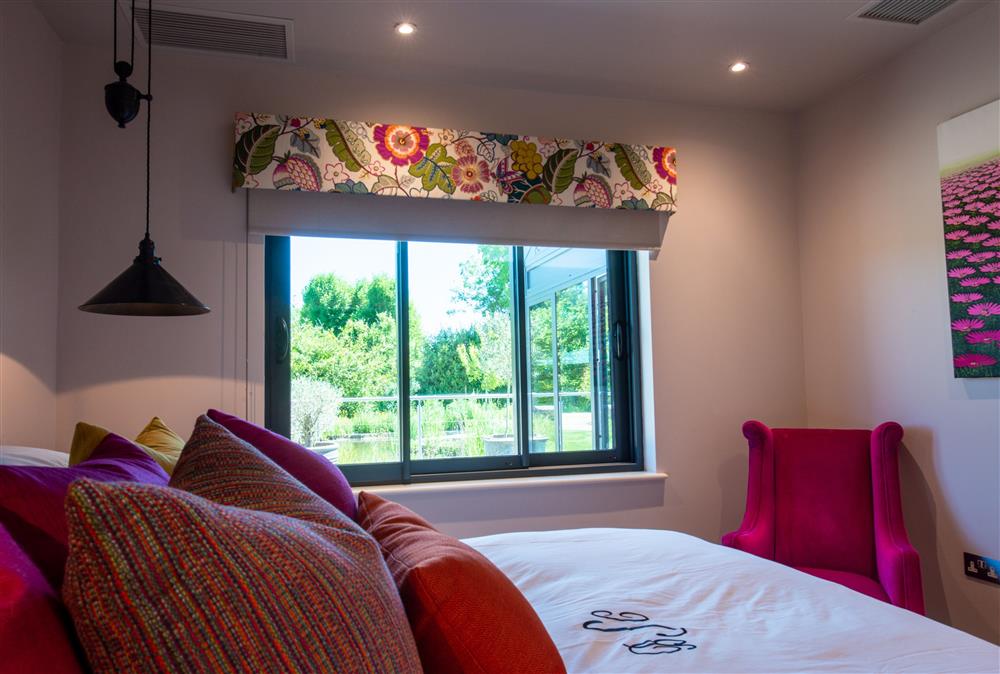 Ground floor: Master bedroom with sumptuous 6ft super-king size bed and views across the beautiful garden