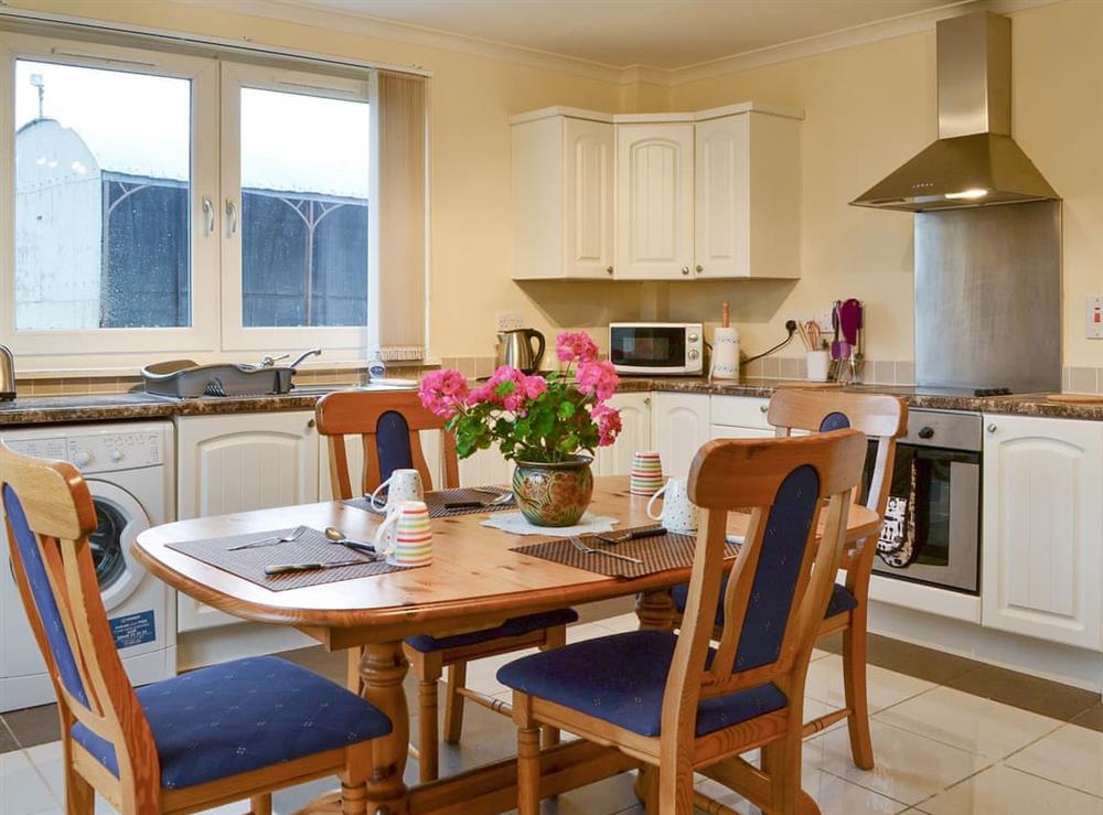 Well-equipped fitted kitchen with dining area at Sylvan Cottage, 