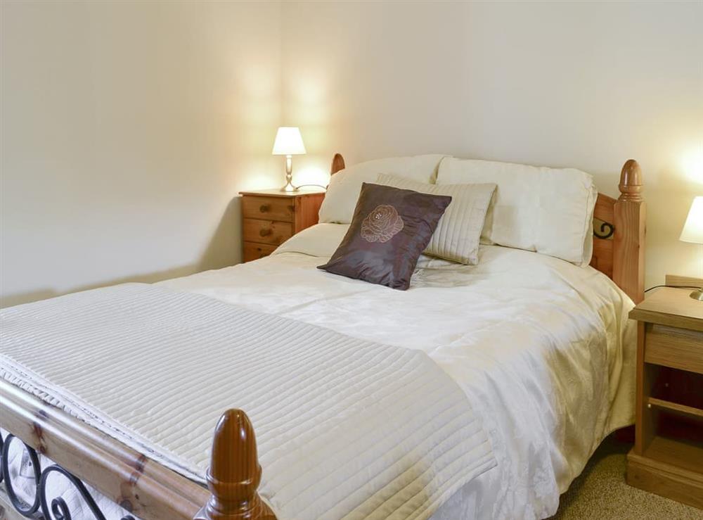 Family bedroom with a double and two single beds at The Granary, 