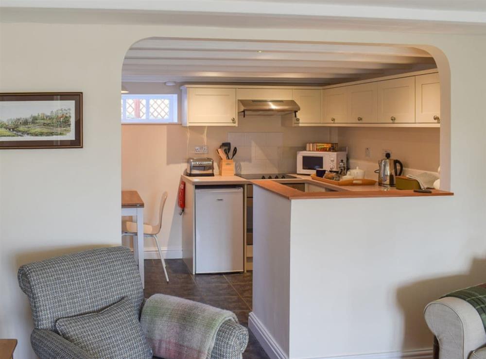 Delightful kitchen/dining area separated by an archway from the living room at Rowan Cottage in Aislaby, near Whitby, Yorkshire, North Yorkshire